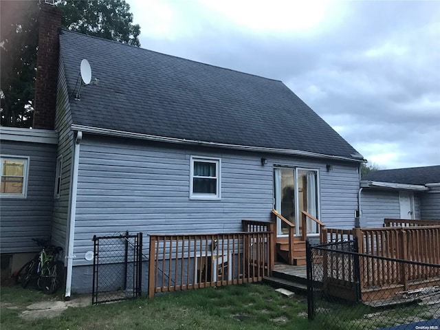 back of house featuring a deck