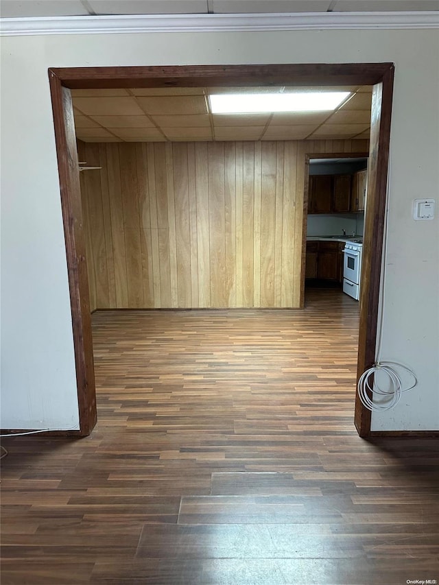 unfurnished room with dark hardwood / wood-style floors and wood walls