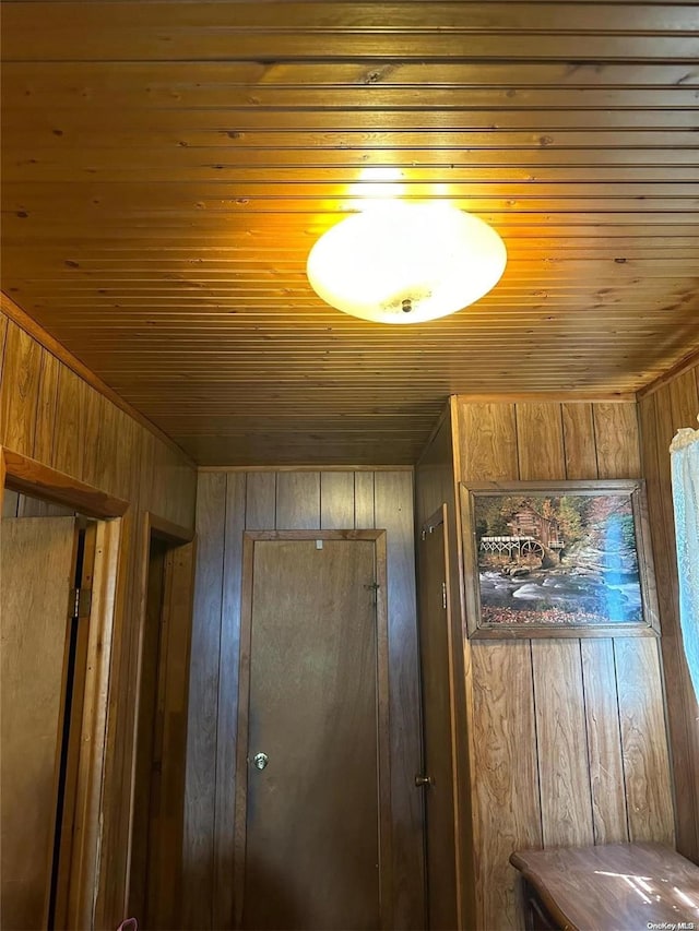 interior details featuring wood ceiling and wood walls