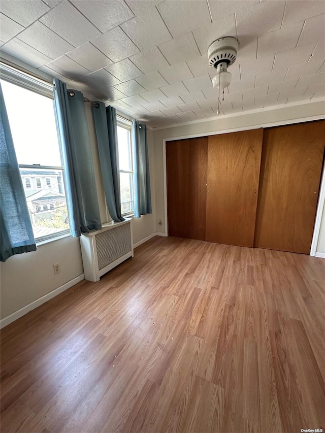 interior space with light hardwood / wood-style floors and radiator