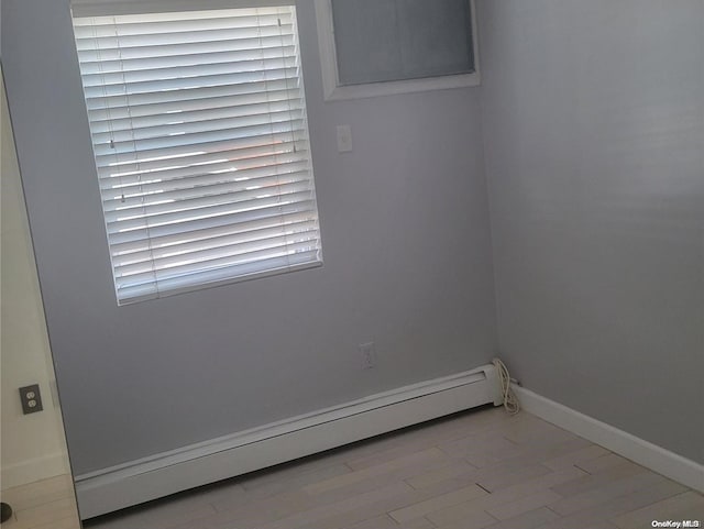 spare room with light hardwood / wood-style flooring and a baseboard radiator