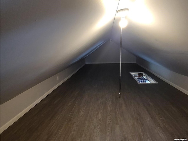 bonus room featuring dark hardwood / wood-style flooring and lofted ceiling