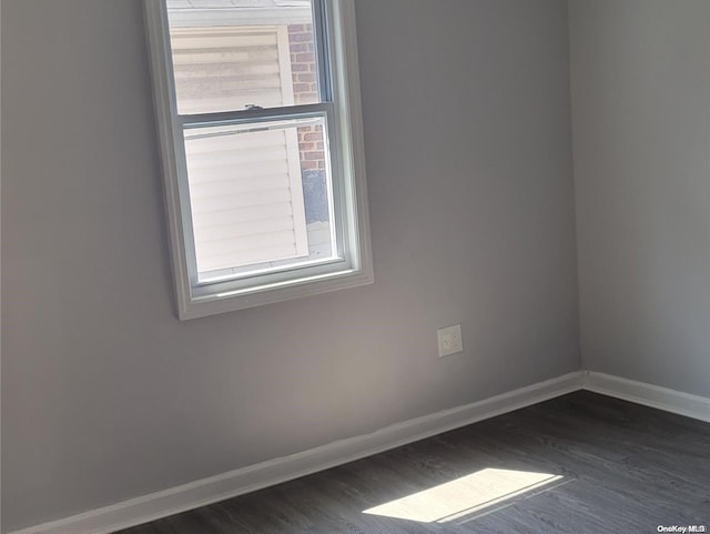 empty room with dark hardwood / wood-style floors