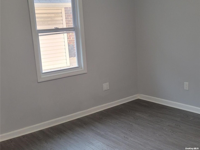 spare room with dark wood-type flooring