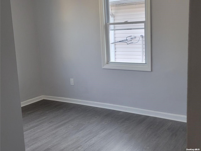 empty room with dark wood-type flooring