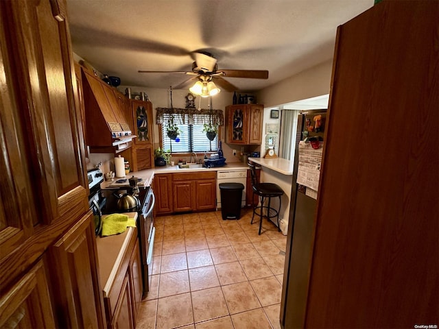 kitchen with ceiling fan, sink, light tile patterned flooring, and appliances with stainless steel finishes