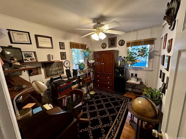 home office with hardwood / wood-style flooring, a wealth of natural light, crown molding, and ceiling fan