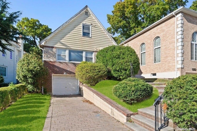 view of front of house with a front lawn and a garage