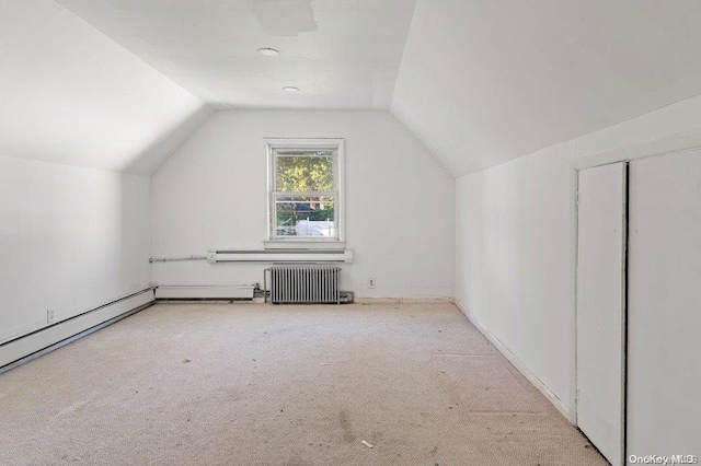 bonus room with light carpet, radiator, and lofted ceiling