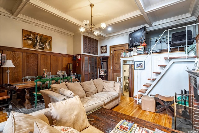 living room with coffered ceiling, crown molding, an inviting chandelier, beamed ceiling, and hardwood / wood-style floors