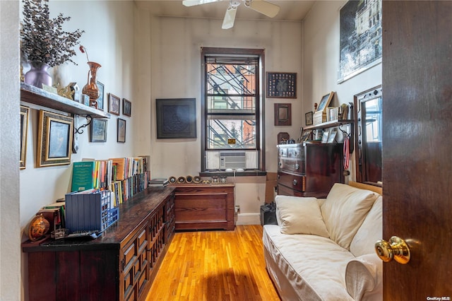 office space with light hardwood / wood-style floors, ceiling fan, and cooling unit