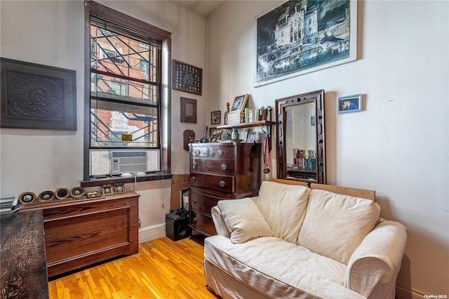 sitting room with light hardwood / wood-style flooring and cooling unit