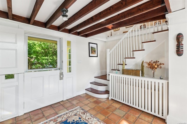 entrance foyer with beamed ceiling, light tile patterned floors, and radiator heating unit