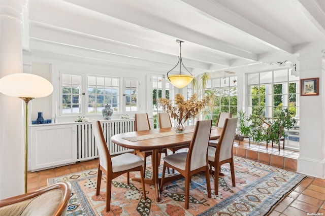 dining area featuring beam ceiling and radiator