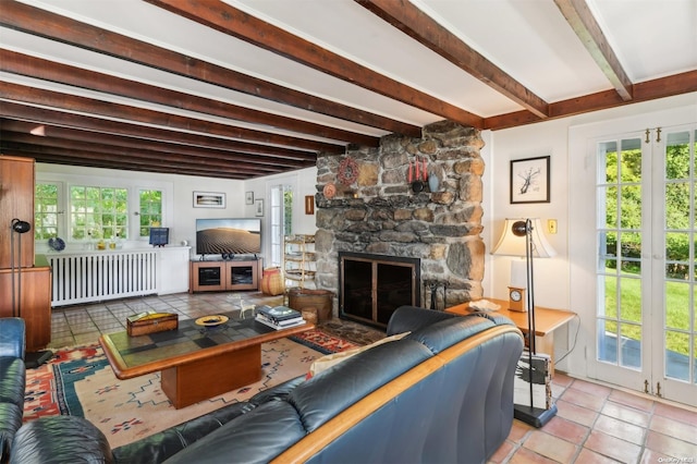 living room featuring beam ceiling, radiator heating unit, french doors, a fireplace, and light tile patterned floors