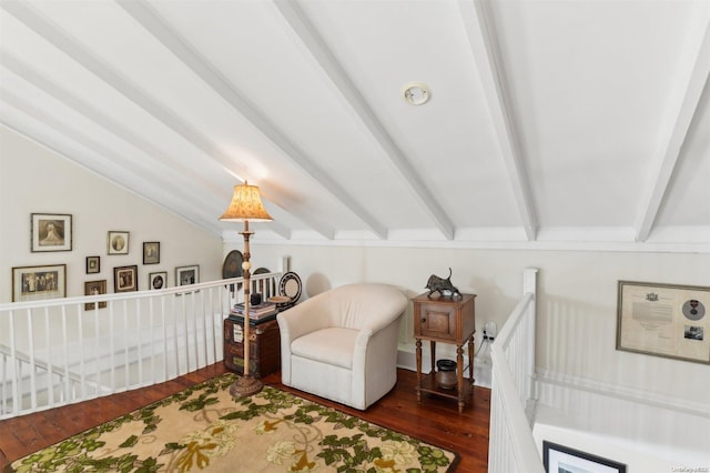 sitting room with dark hardwood / wood-style flooring and lofted ceiling with beams