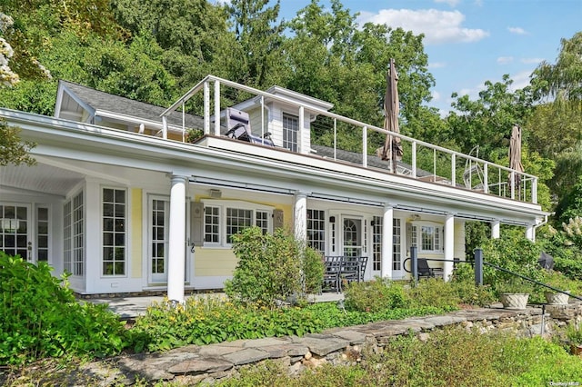 back of house with a balcony and covered porch