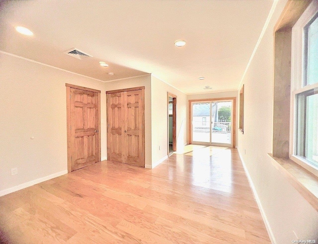 interior space featuring crown molding and light wood-type flooring