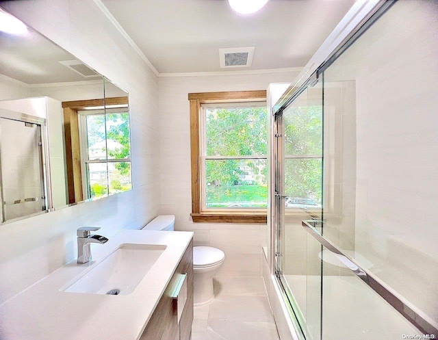 bathroom featuring vanity, crown molding, toilet, walk in shower, and tile walls