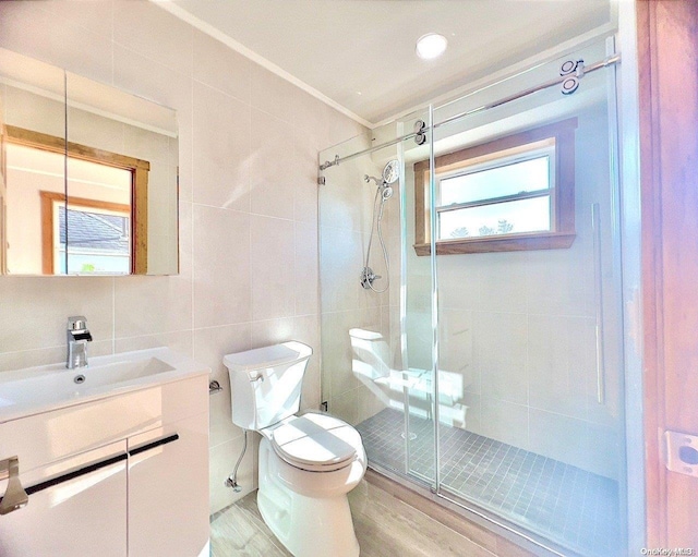 bathroom with vanity, hardwood / wood-style flooring, toilet, tile walls, and walk in shower