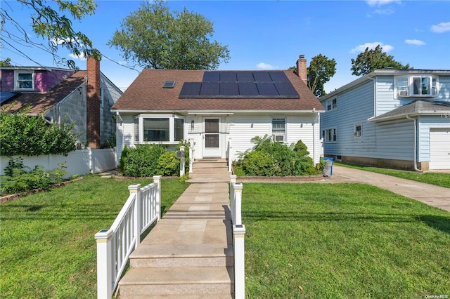 view of front of property featuring solar panels and a front lawn