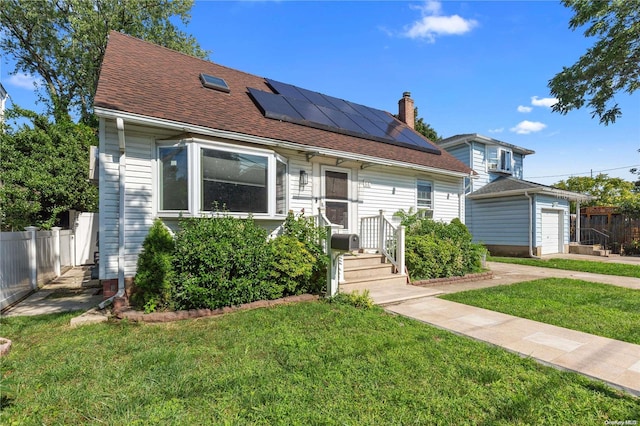 view of front facade with a front lawn, a garage, and solar panels