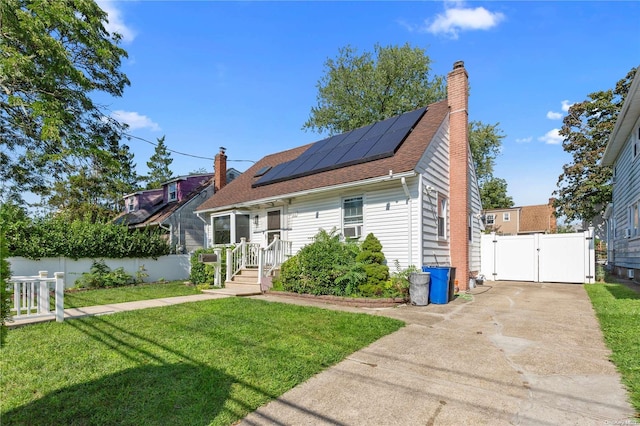 view of front of house with solar panels and a front lawn