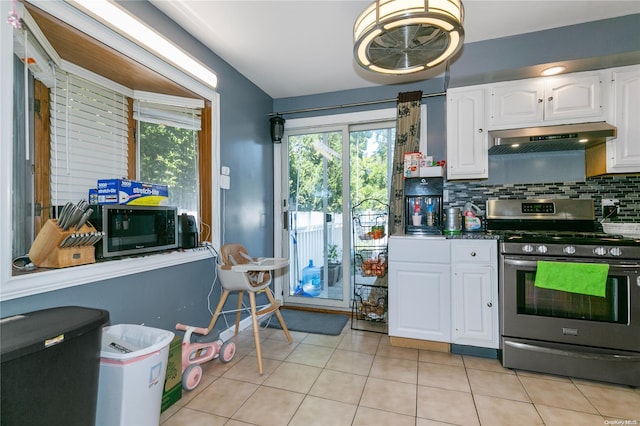 kitchen with light tile patterned flooring, decorative backsplash, white cabinets, and stainless steel appliances