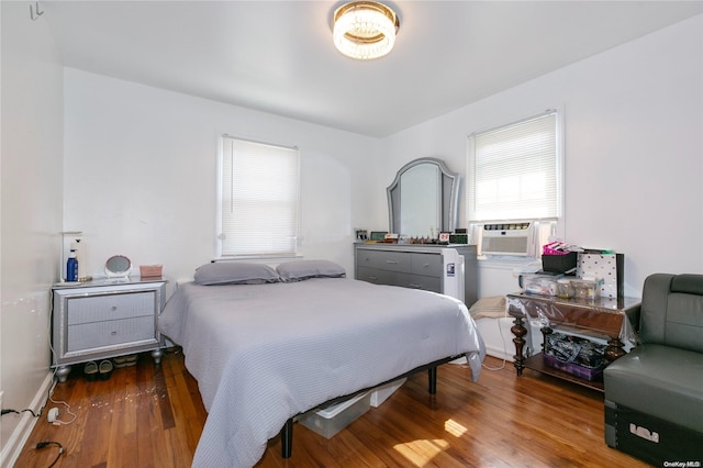 bedroom featuring dark hardwood / wood-style floors and cooling unit