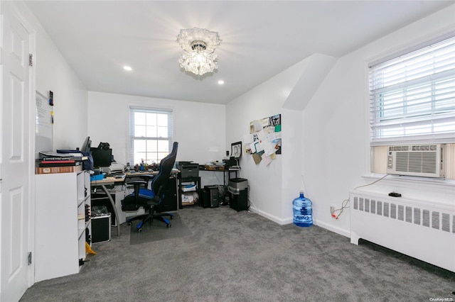 office space featuring carpet, radiator heating unit, an inviting chandelier, and cooling unit