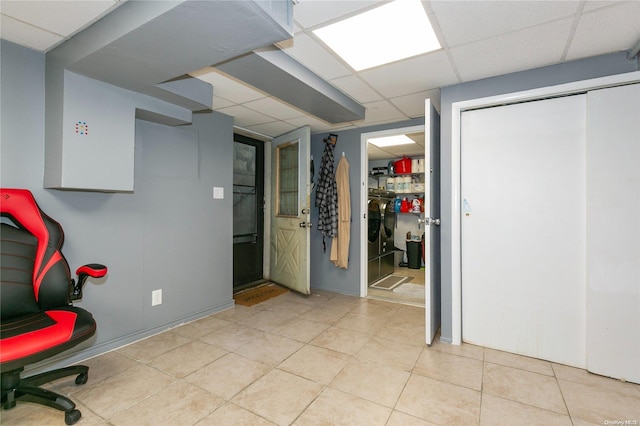 office with a paneled ceiling and light tile patterned flooring