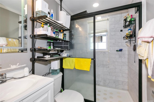 bathroom featuring walk in shower, toilet, vanity, and ornamental molding