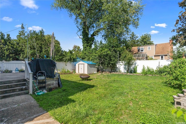 view of yard with a deck and a storage shed