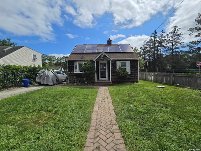 bungalow with solar panels and a front yard