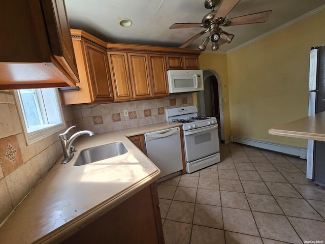 kitchen featuring sink, a baseboard radiator, tasteful backsplash, white appliances, and light tile patterned floors