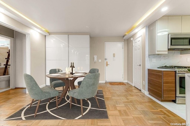 dining room featuring light parquet floors