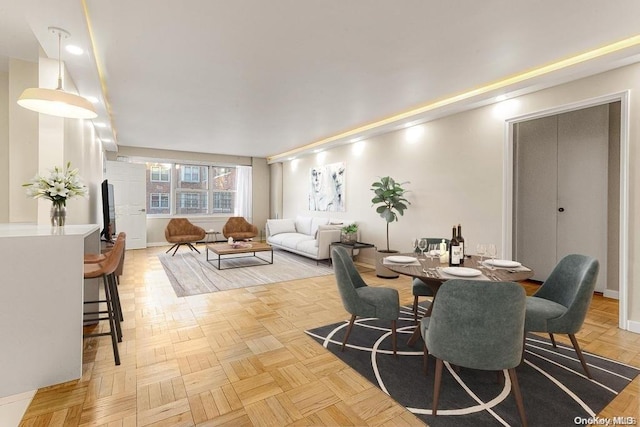 dining space featuring light parquet floors