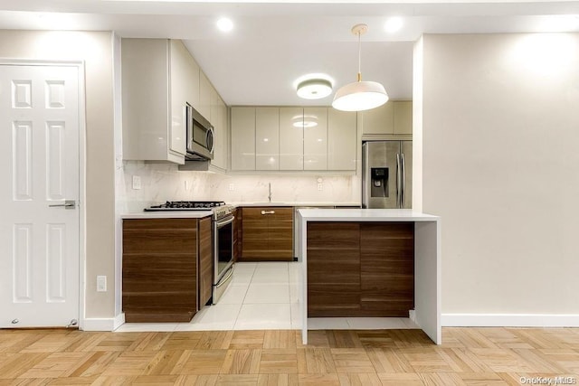 kitchen with white cabinets, pendant lighting, decorative backsplash, light parquet flooring, and appliances with stainless steel finishes