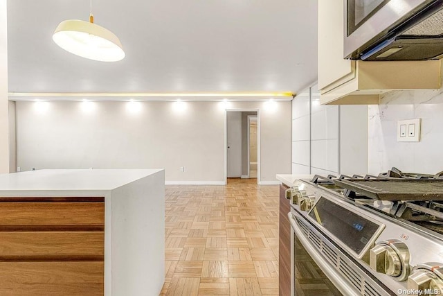 kitchen featuring pendant lighting, stainless steel appliances, and light parquet floors