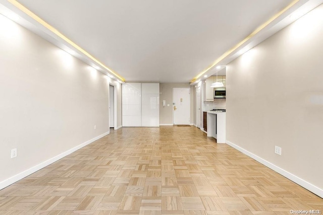 unfurnished living room featuring light parquet flooring