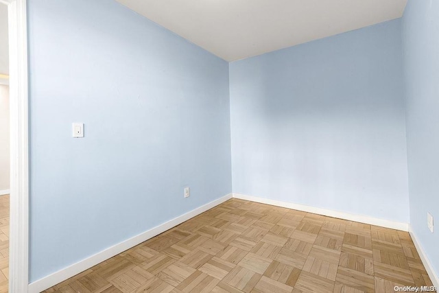 unfurnished room featuring light parquet flooring