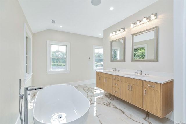 66 Peters Ln, Westhampton Beach, NY 11978 - bathroom with double vanity, marble tiled flooring, a soaking tub, recessed lighting, and vaulted ceiling