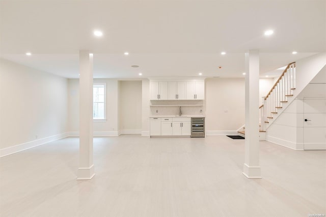 66 Peters Ln, Westhampton Beach, NY 11978 - below grade area featuring wine cooler, stairs, and recessed lighting