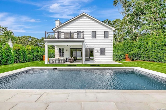 66 Peters Ln, Westhampton Beach, NY 11978 - rear view of house featuring a balcony, ceiling fan, outdoor lounge area, a lawn, and a chimney