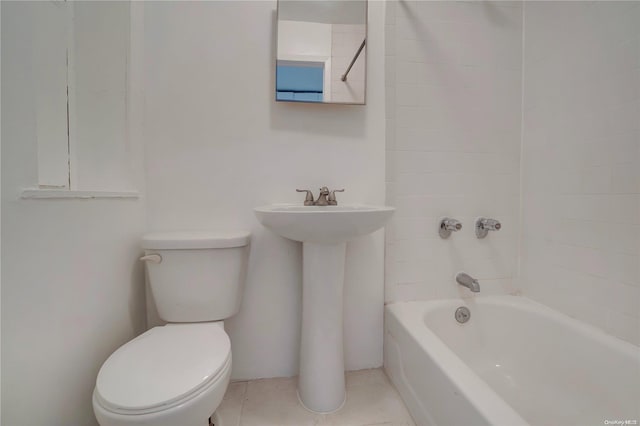 full bathroom with sink, tile patterned flooring, tiled shower / bath, and toilet