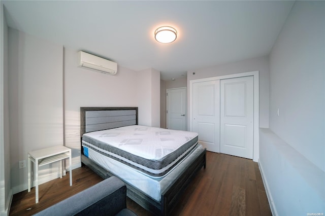 bedroom featuring a wall mounted air conditioner, dark hardwood / wood-style floors, and a closet