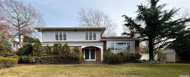 view of front facade featuring a front yard and french doors