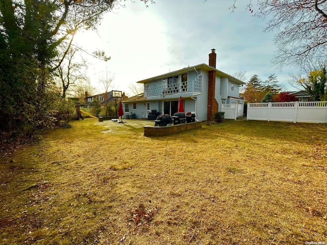 rear view of property featuring a yard