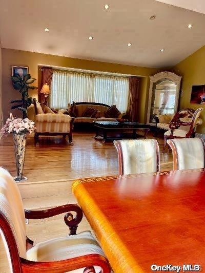 interior space with hardwood / wood-style floors and vaulted ceiling