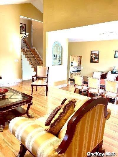 living room with lofted ceiling and hardwood / wood-style flooring